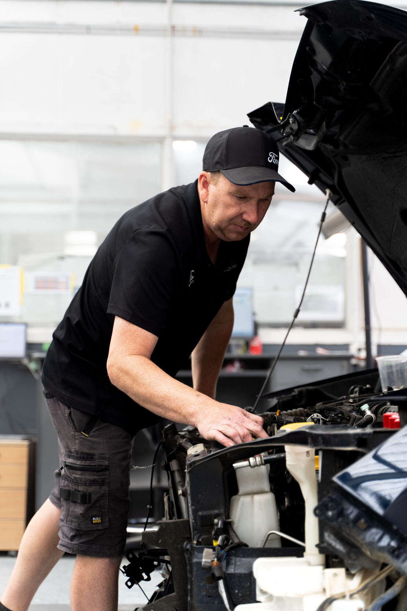 Technician working on a vehicle in the Sockburn workshop