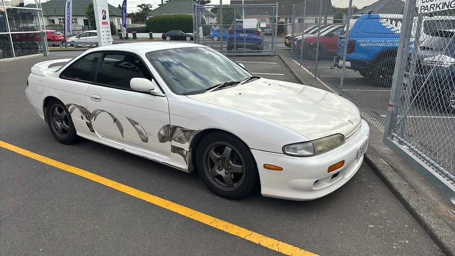 Collision-damaged Silvia with panel markings, side view